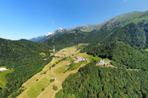 an aerial view of a golf course in the mountains at Country house At Peskar`s in Podbrdo