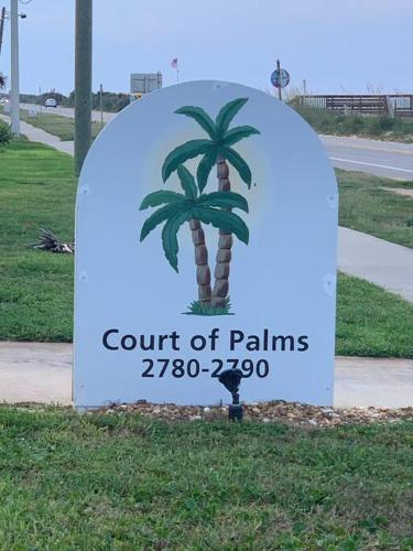 a sign for a court of palms with a palm tree at Ormond Beach, fun & loving sun! in Ormond Beach