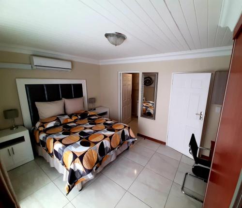 a bedroom with a large bed in a room at Masechaba guesthouse in Vanderbijlpark