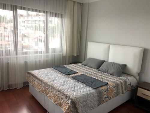 a bedroom with a large bed with a window at WHİTE HOUSE in Trabzon