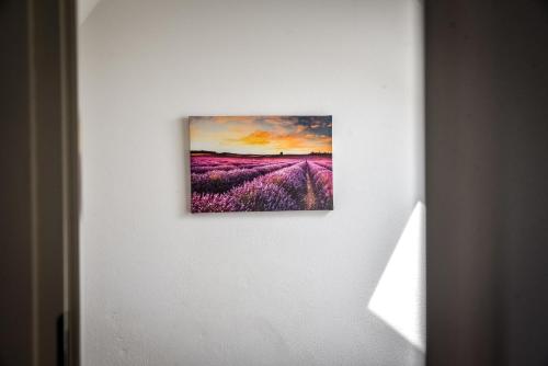 a painting of a lavender field on a wall at Apartamenty Dwupoziomowe Na Dwa Widoki z Jacuzzi & Sauna in Zakopane