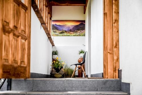 a house with a view of the front porch with a painting at Apartamenty Dwupoziomowe Na Dwa Widoki z Jacuzzi & Sauna in Zakopane