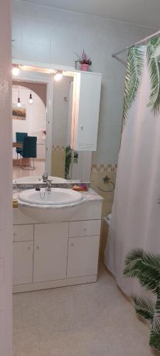 a bathroom with a sink and a shower curtain at Selene in Calpe