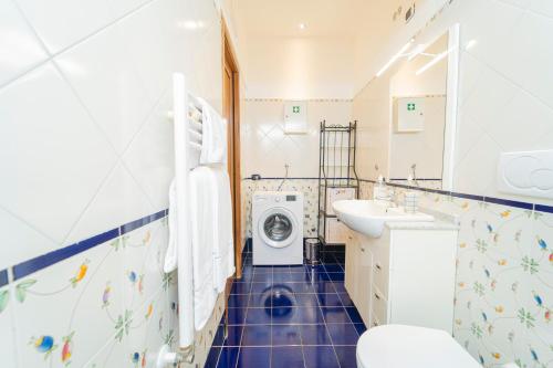 a bathroom with a washing machine and a washer and dryer at Residenza Sant'Angelo - Art Apartment in Minori