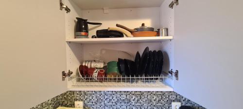 a kitchen shelf with utensils in a kitchen at Αργέντη in Chios