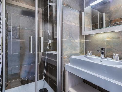 a bathroom with a glass shower and a sink at Appartement moderne à Courchevel Village, près des commerces et pistes, parking et salle de fitness inclus - FR-1-562-38 in Courchevel