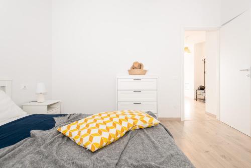 a bedroom with a bed with a pillow on it at Mamo's Belvedere by Holiday Solutions in Faggeto Lario 
