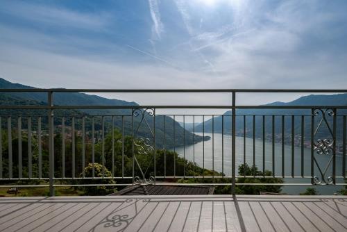 a balcony with a view of a body of water at Mamo's Belvedere by Holiday Solutions in Faggeto Lario 
