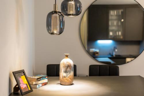 a vase sitting on a table in front of a mirror at Flaka's Apartment in Vienna