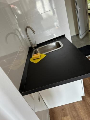 a kitchen counter with a sink and a yellow tag at Gostilna in apartmaji Zlati lev - Maribor in Maribor