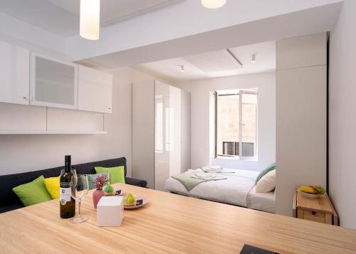 a kitchen and living room with a table and a bed at Main Square Apartment in Hvar