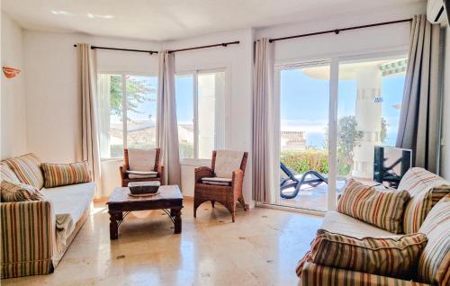 a living room with two couches and a table at Lovely Apartment In Mijas With Wifi in Mijas