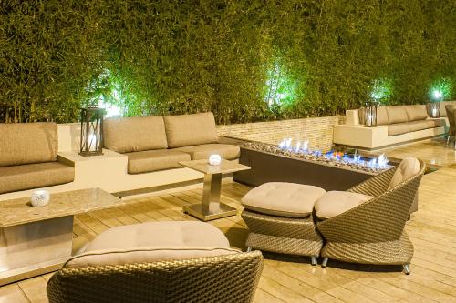 a living room with couches and chairs and a table at Hotel Cabrera Imperial By key 33 in Bogotá