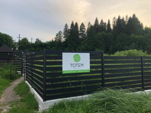 a black fence with a totten sign on it at TOTEM in Skhidnitsa