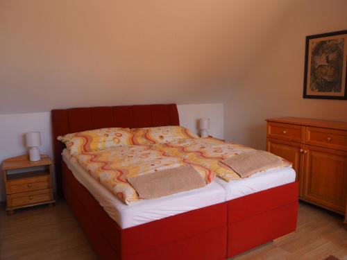a bedroom with a bed with a red frame at Privat Alenka in Liptovský Mikuláš