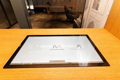 an ipad on a table in a room at MM Boutique Hotel in Burgas City