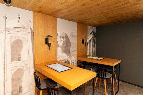 a room with two tables and a painting on the wall at MM Boutique Hotel in Burgas City