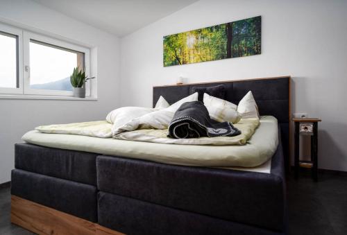 a bedroom with a bed with a black headboard at Haus Nordketten Blick in Schönberg im Stubaital