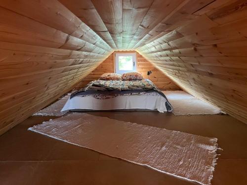 a bed in a small room in a log cabin at Vahtra Beach House in Käsmu