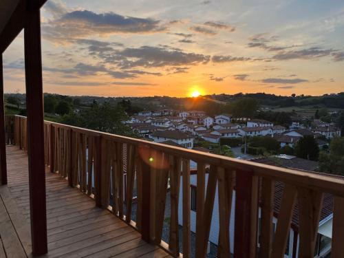 a view of a sunset from the balcony of a house at Chalet Eguzkitsua 3 étoiles avec piscine et barbecue - pays basque - in Hasparren