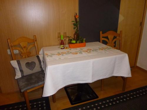 a table with a white table cloth on it at Ferienwohnungen Hauser in Waidring