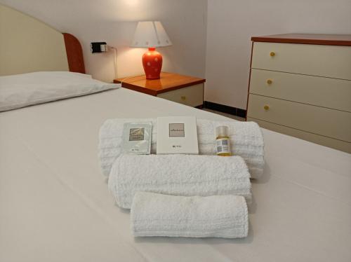 a bedroom with a bed with towels on it at CasaGiulia Calasetta in Calasetta