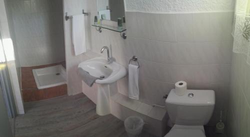a bathroom with a toilet and a sink at Hotel La Reserve in Vic-la-Gardiole