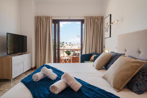a bedroom with a large bed with towels on it at Santa Rosa La Peñita (Puerto del Carmen) in Puerto del Carmen
