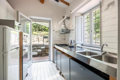 a kitchen with a sink and a refrigerator at Il Casale in Pistoia