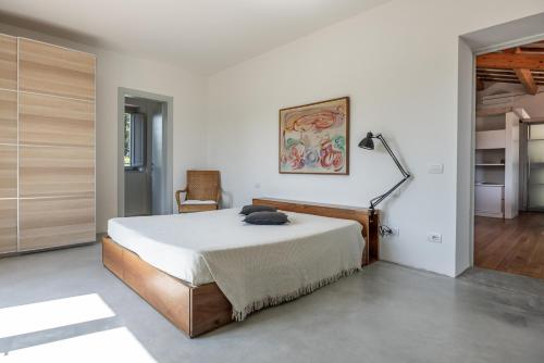 a bedroom with a bed and a lamp in it at Il Casale in Pistoia