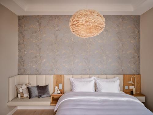 a bedroom with a large bed and a pendant light at 1884 Norderney in Norderney