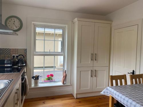 a kitchen with a window and a table at The Lodge Donegal Town in Donegal