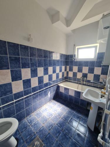 a bathroom with a tub and a toilet and a sink at Apartman K2 in Kraljevo
