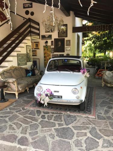 a white car is parked in a garage at "Ai 4 Soli" in Cermenate