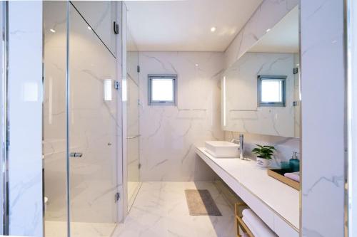 a bathroom with a shower and a sink at Namhae Bay 591 in Namhae