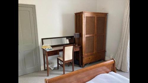 a bedroom with a desk and a cabinet next to a bed at Central Truro! Large Double Room In Victorian Property in Truro