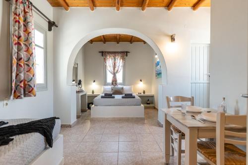 a bedroom in a villa with a bed and a table at Michalios Luxury Apartments in Koufonisia