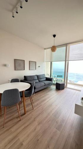 a living room with a couch and a table at Le bellevue apartment in Llogara