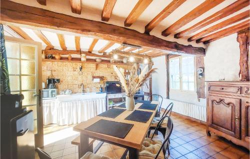a dining room with a table and a kitchen at Pet Friendly Home In Touffreville in Touffreville