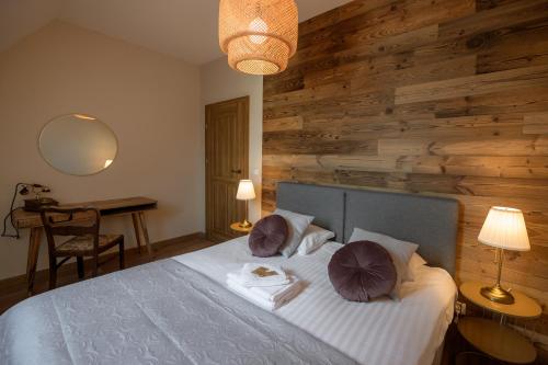 a bedroom with a bed with two pillows on it at Narnia Apartment in Toruń
