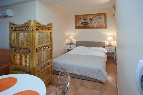 a bedroom with a bed and two tables and two lamps at Residence Apartments Anamaria in Podstrana