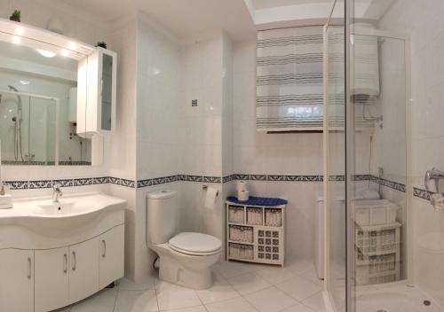 a bathroom with a toilet and a sink and a shower at Residence Apartments Anamaria in Podstrana