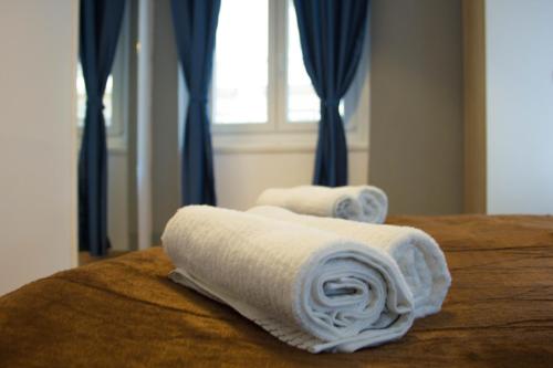 Duas toalhas brancas numa cama com uma janela em City Center Apartment Dina 3 em Rijeka