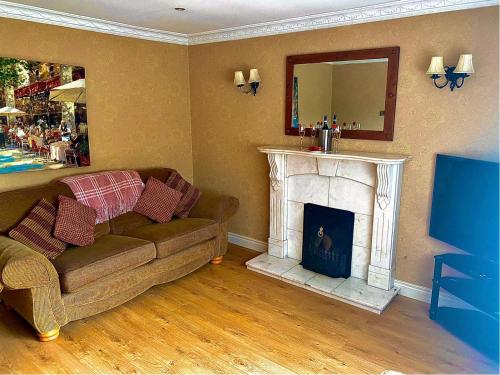 a living room with a couch and a fireplace at Glenview Cottage in Keady