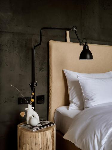 a bedroom with a bed and a table with a lamp at 1884 Norderney in Norderney