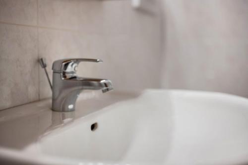 a sink with a faucet in a bathroom at Lindenhof Apt 7 in Vandoies