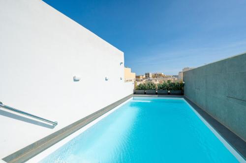 a swimming pool in the side of a building at Battistini Boutique Living Hotel and Spa, Victoria, Gozo in Victoria