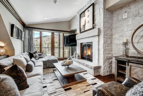 a living room with a couch and a fireplace at Ritz 2Br R614 in Vail