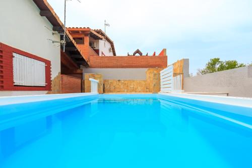a swimming pool in front of a house at Can Prats in Ríudecañas