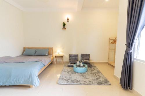 a bedroom with a bed and a rug at Cloud River Homestay in Da Lat